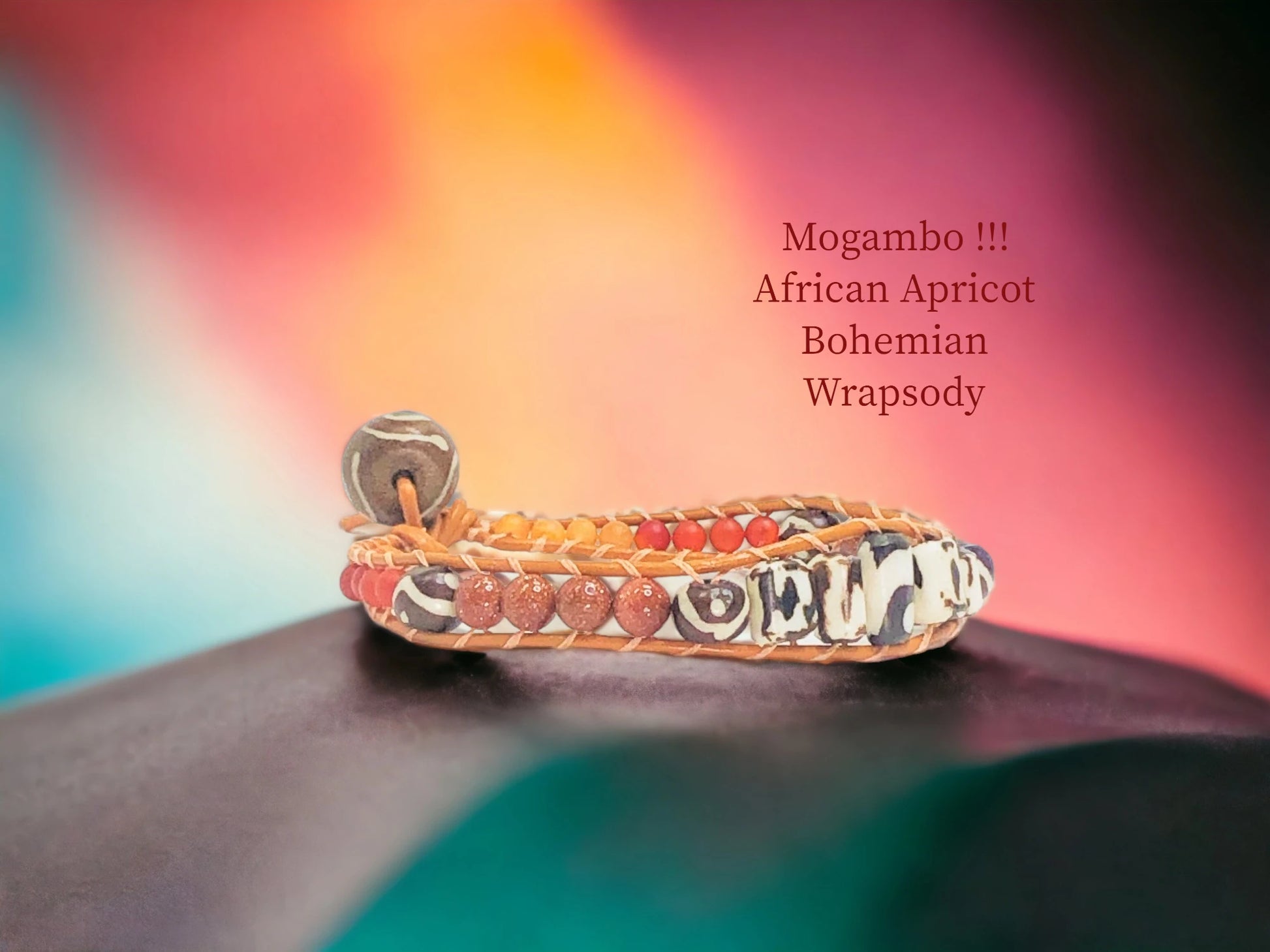 Mogambo African Apricot Bohemian Wrapsody with Orange genuine leather encasing Hand painted Bone, Sandstone, wood, Carnelian and Orange Crackle Agate beads. wooden painted bead closure. $41.99