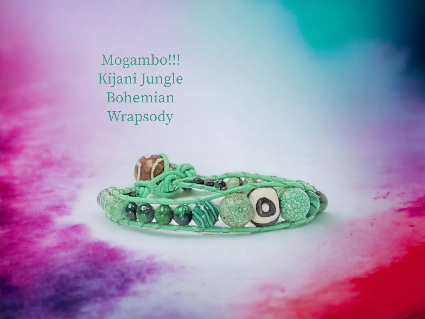 Mogambo Kijani Jungle Bohemian Wrapsody with Green genuine leather encasing a handpainted bone bead focal with Moss Agate, Malachite, and Tiger's Eye beads. Handpainted wood bead closure., $49.99