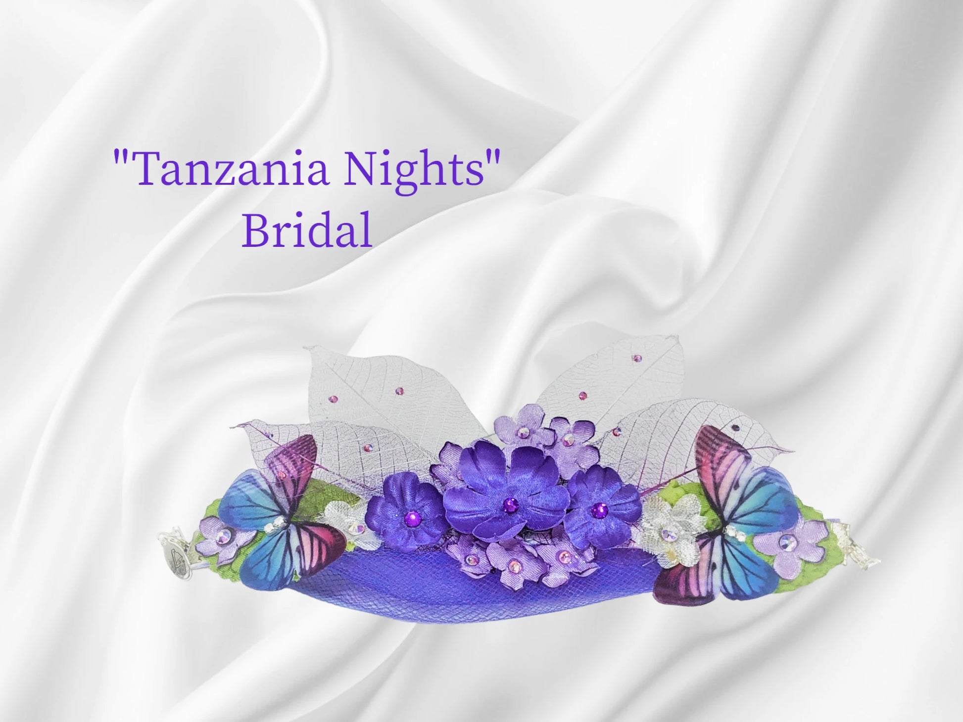 Tanzanite is a color favorite!!! Twin butterflies bookend a flurry of tanzanite silk and Austrian Crystal centered flowers and 2 sets of skeleton leaves with tiny tanzanite Austrian Crystal dew drops. Tanzanite tulle is the lovely backdrop for this beautiful arm piece. $43.99