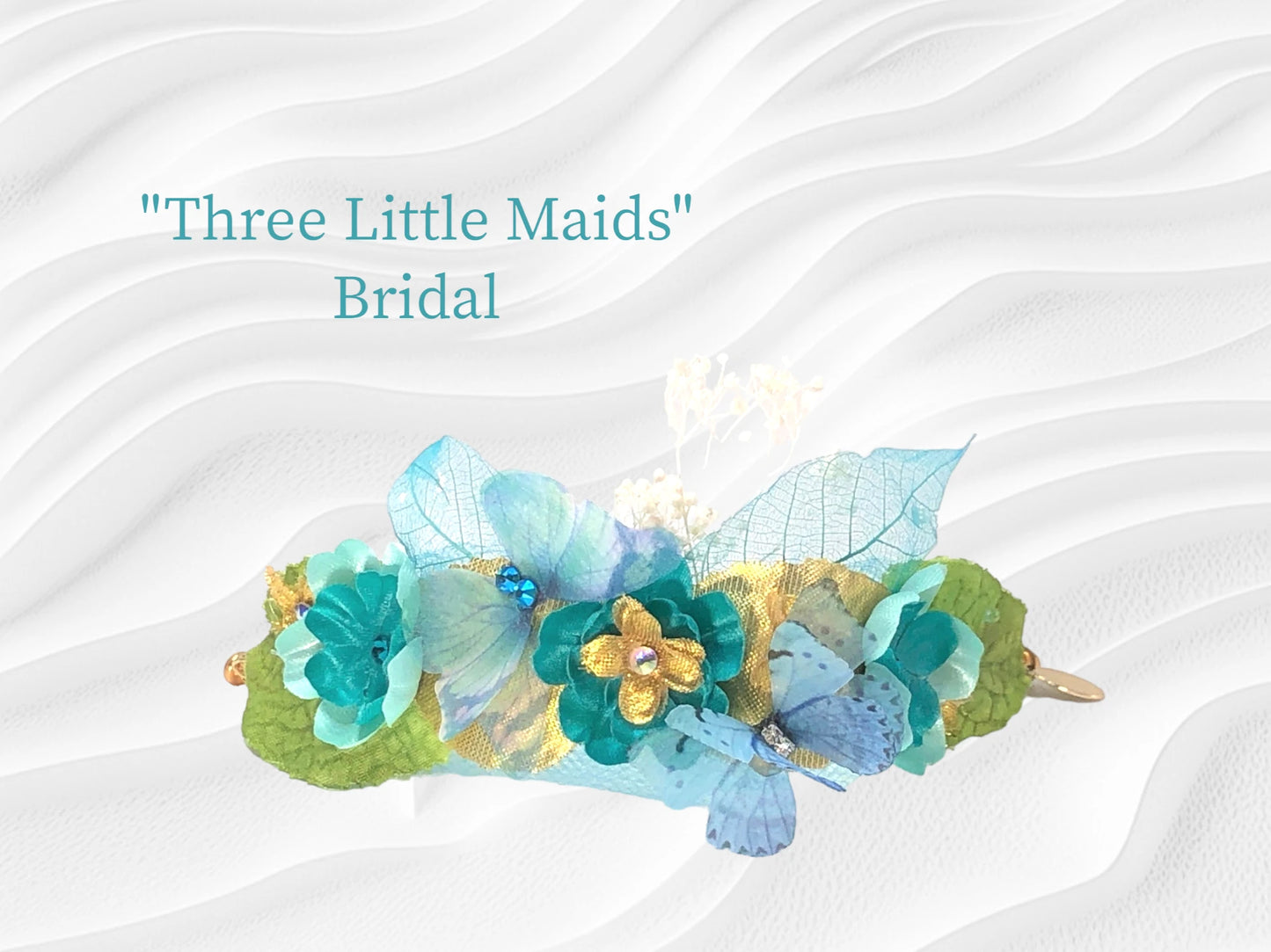 Three Little Maids-Lightweight magnetic closure bracelet w/ 3 contrasting Teal silk flowers and crystal centers. Green silk leaves, dried baby's breath, gold lame' leaves and flowers with crystal centers, Teal chiffon and crystal butterfly, Teal skeleton leaves, with crystal dew drops and delicate matching Tulle make up this wedding arm piece. $46.99