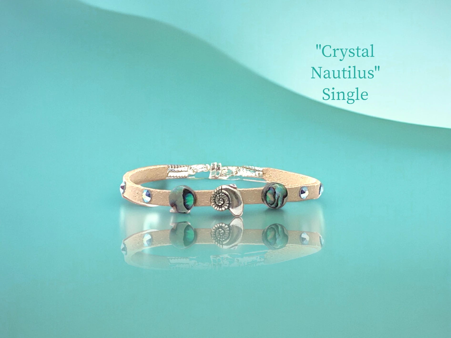 Single wrap with shimmering Aquamarine Austrian Crystal studs and a Abalone & Silver nautilus focal. $24.99